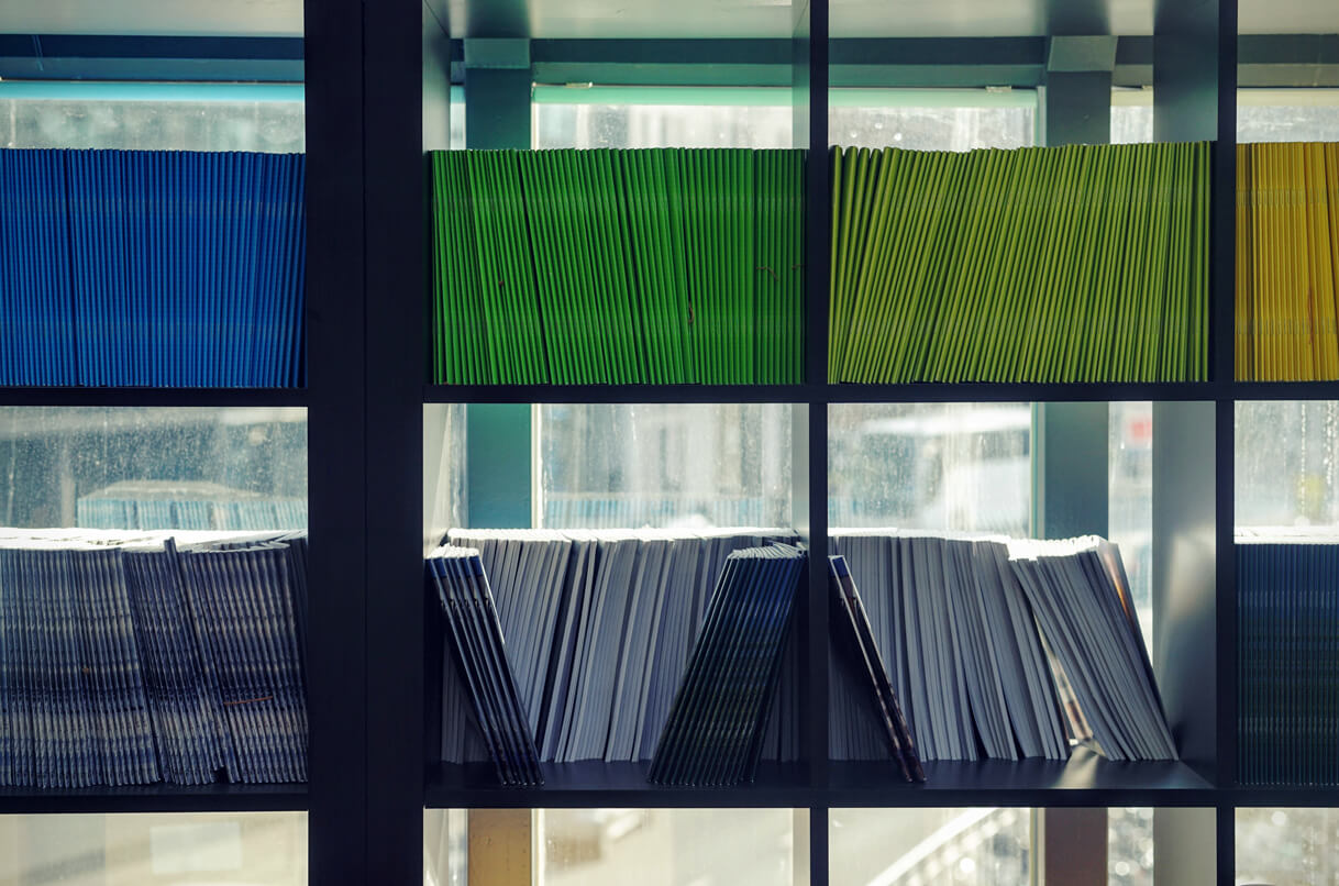A shelf with colored magazines